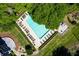 Aerial view of the community swimming pool, deck area, and lush landscaping at 1445 Monroe Ne Dr # F12, Atlanta, GA 30324