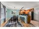 Dining area open to kitchen with breakfast bar and seating, natural light and a modern chandelier at 1445 Monroe Ne Dr # F12, Atlanta, GA 30324