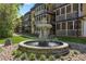 Exterior view of the multi-story building with screened porches and a charming fountain at 1445 Monroe Ne Dr # F12, Atlanta, GA 30324