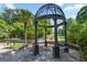 Exterior gazebo with seating in a landscaped area and a view of the pool in the background at 1445 Monroe Ne Dr # F12, Atlanta, GA 30324