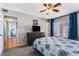 Comfortable main bedroom with ceiling fan, dresser with TV, and private balcony at 1445 Monroe Ne Dr # F12, Atlanta, GA 30324