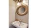 Stylish powder room featuring a modern mirror, sink, and attractive lighting fixture at 2094 Green Gate Pl, Grayson, GA 30017