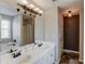 Bathroom featuring double vanity, large mirror, and a soaking tub with a window view at 2094 Green Gate Pl, Grayson, GA 30017