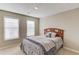 Neutral bedroom with carpet, windows, and a bed with a wooden headboard and decorative pillows at 2094 Green Gate Pl, Grayson, GA 30017