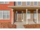 Welcoming front porch features sturdy columns and a charming, traditional front door at 2094 Green Gate Pl, Grayson, GA 30017