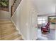 Hallway with carpeted stairs, white walls, and wood flooring leading to the living room area at 2094 Green Gate Pl, Grayson, GA 30017