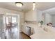 Bright kitchen featuring white countertops, a stainless steel dishwasher, and hardwood floors at 2094 Green Gate Pl, Grayson, GA 30017