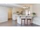 Well-lit kitchen with white cabinetry, bar seating, and an open layout with hardwood floors at 2094 Green Gate Pl, Grayson, GA 30017