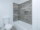 Bathroom featuring modern tub with beautifully tiled walls, and modern fixtures at 2493 Swallow Cir, Atlanta, GA 30315