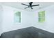 Bright bedroom featuring dark wood floors, ceiling fan, and two windows at 2493 Swallow Cir, Atlanta, GA 30315