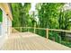 Inviting wooden deck surrounded by vibrant, lush trees at 2493 Swallow Cir, Atlanta, GA 30315