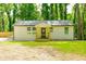 Inviting exterior showcasing a newly renovated home with a quaint porch and well-manicured lawn at 2493 Swallow Cir, Atlanta, GA 30315