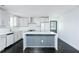 Bright kitchen boasts an island, white cabinets, and stainless steel appliances at 2493 Swallow Cir, Atlanta, GA 30315