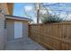 Fenced backyard space with side storage unit and concrete patio under the eaves at 413 Northdale Ct, Lawrenceville, GA 30046