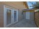 Backyard patio area with french doors to the home, storage unit and fenced yard at 413 Northdale Ct, Lawrenceville, GA 30046