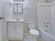 Bright bathroom featuring a white vanity, toilet, mirror, and tiled shower/tub combination at 413 Northdale Ct, Lawrenceville, GA 30046