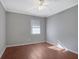 Bright bedroom featuring wood floors, a ceiling fan, neutral paint, and natural light at 413 Northdale Ct, Lawrenceville, GA 30046