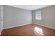 Neutral bedroom with hardwood floors, ceiling fan, and natural light from a window at 413 Northdale Ct, Lawrenceville, GA 30046