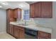 Bright kitchen view featuring stainless steel sink, white countertops, and dark wood cabinetry at 413 Northdale Ct, Lawrenceville, GA 30046