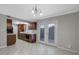 Open floor plan kitchen with dark cabinets, stainless sink, and adjacent patio doors at 413 Northdale Ct, Lawrenceville, GA 30046