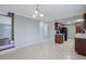 Open kitchen leading to a staircase, featuring dark wood cabinetry and tile flooring at 413 Northdale Ct, Lawrenceville, GA 30046