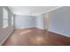 Sunlit living room with hardwood floors, neutral walls, and modern lighting at 413 Northdale Ct, Lawrenceville, GA 30046