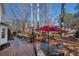 Backyard deck featuring a patio table and chairs with an umbrella and wooded view at 4172 Westchester Ne Xing, Roswell, GA 30075