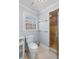 Bathroom featuring a toilet, corner shower with glass door, and natural light from the window at 4172 Westchester Ne Xing, Roswell, GA 30075