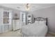 Bedroom featuring carpet, natural light from the windows, dresser, bookshelf and a fan at 4172 Westchester Ne Xing, Roswell, GA 30075