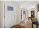 Inviting foyer with decorative front door, wood floors, and view into the dining room at 4172 Westchester Ne Xing, Roswell, GA 30075