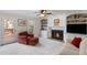 Living room featuring built-in shelves, fireplace, and access to the outdoor deck at 4172 Westchester Ne Xing, Roswell, GA 30075