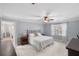 A cozy main bedroom features neutral carpet, ceiling fan, and bright windows with natural light at 4172 Westchester Ne Xing, Roswell, GA 30075