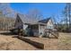 The backyard displays the screened-in porch, the house's siding, and the surrounding trees at 459 Rabbit Run, Mcdonough, GA 30252