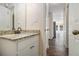 Hallway view of bathroom with a granite countertop, single sink vanity, and a view to the living area at 459 Rabbit Run, Mcdonough, GA 30252