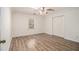 Bright bedroom with hardwood floors, ceiling fan, large closet, and a window at 459 Rabbit Run, Mcdonough, GA 30252