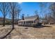 A single-story home showcasing a cozy covered front porch and mature trees on a sunny day at 459 Rabbit Run, Mcdonough, GA 30252