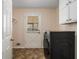 Well-lit laundry room featuring a modern washing machine and ample storage space above appliance at 459 Rabbit Run, Mcdonough, GA 30252