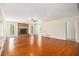 Living area showcasing hardwood floors, a cozy brick fireplace, and well-lit open space at 459 Rabbit Run, Mcdonough, GA 30252