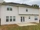 Back of house featuring an outdoor concrete patio with light siding and dark roof at 7597 Cole Ln, Atlanta, GA 30349