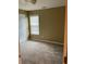 Bedroom featuring neutral walls, one window, and a white door at 7597 Cole Ln, Atlanta, GA 30349