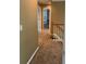 Hallway with neutral walls leads to rooms and stairs with white railing at 7597 Cole Ln, Atlanta, GA 30349