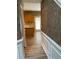 Hallway with textured wall, hardwood floors, and views of the kitchen at 7597 Cole Ln, Atlanta, GA 30349