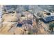 Aerial view of a single-story brick home, showcasing the roof, yard, and nearby buildings at 1141 Milstead Ne Ave, Conyers, GA 30012