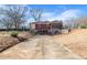 Picture of the backyard of a home with stone accents, featuring an expansive driveway at 1141 Milstead Ne Ave, Conyers, GA 30012