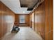 Basement area with wood paneling, tile flooring, and a small window for natural light at 1141 Milstead Ne Ave, Conyers, GA 30012