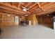 Unfinished basement with exposed wood ceiling and tile flooring, offering storage and a motorcycle at 1141 Milstead Ne Ave, Conyers, GA 30012