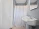 Bathroom with a pedestal sink, white hexagon tiled floor and a shower at 1141 Milstead Ne Ave, Conyers, GA 30012