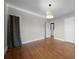 Sunlit bedroom with hardwood floors, a ceiling light, and a closet at 1141 Milstead Ne Ave, Conyers, GA 30012