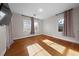 Bedroom with neutral walls, natural light from windows and hardwood floors at 1141 Milstead Ne Ave, Conyers, GA 30012