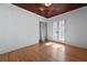 Bright bedroom features hardwood floors, white walls, and French doors leading to an outdoor space at 1141 Milstead Ne Ave, Conyers, GA 30012